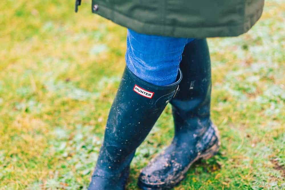 Woman wearing hunter boots with antibacterial lining.