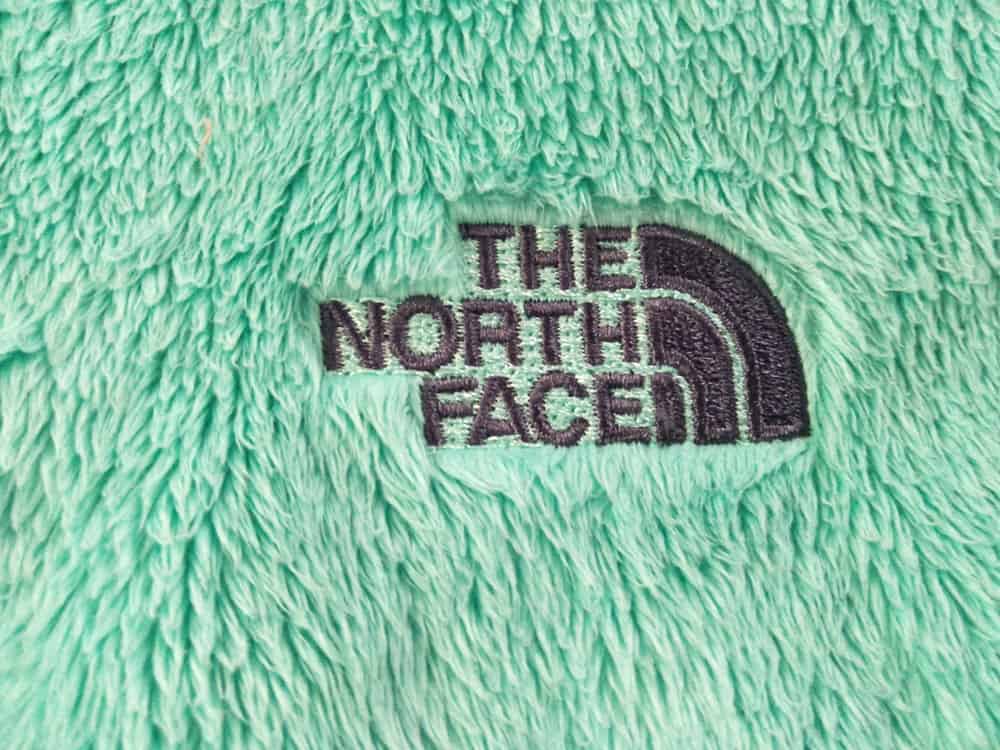Fleece jacket with The North Face logo.