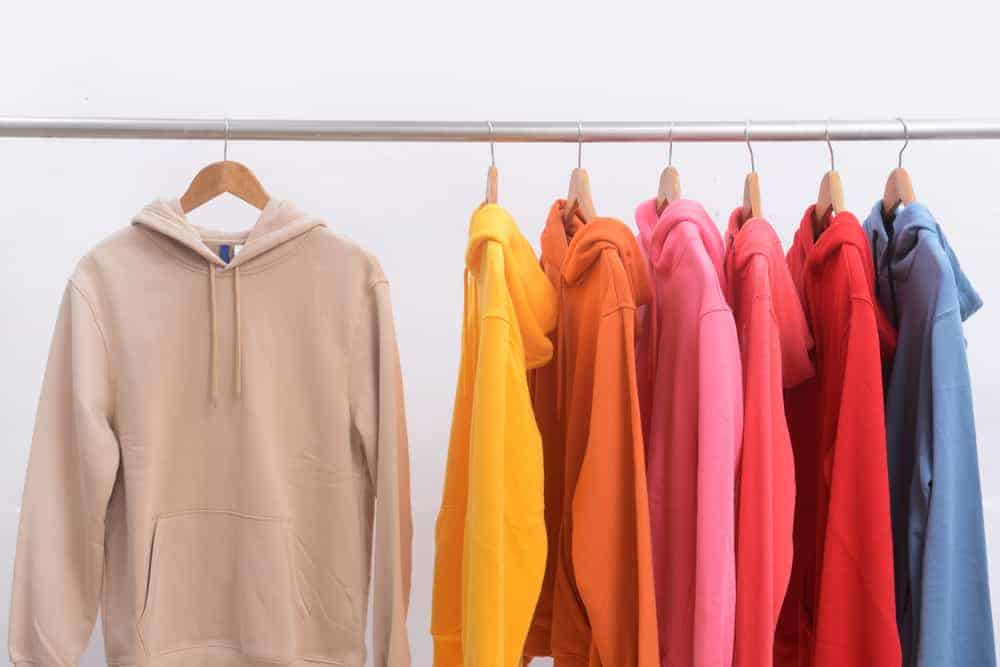 This is a close look at a rack of hoodies in different colors.