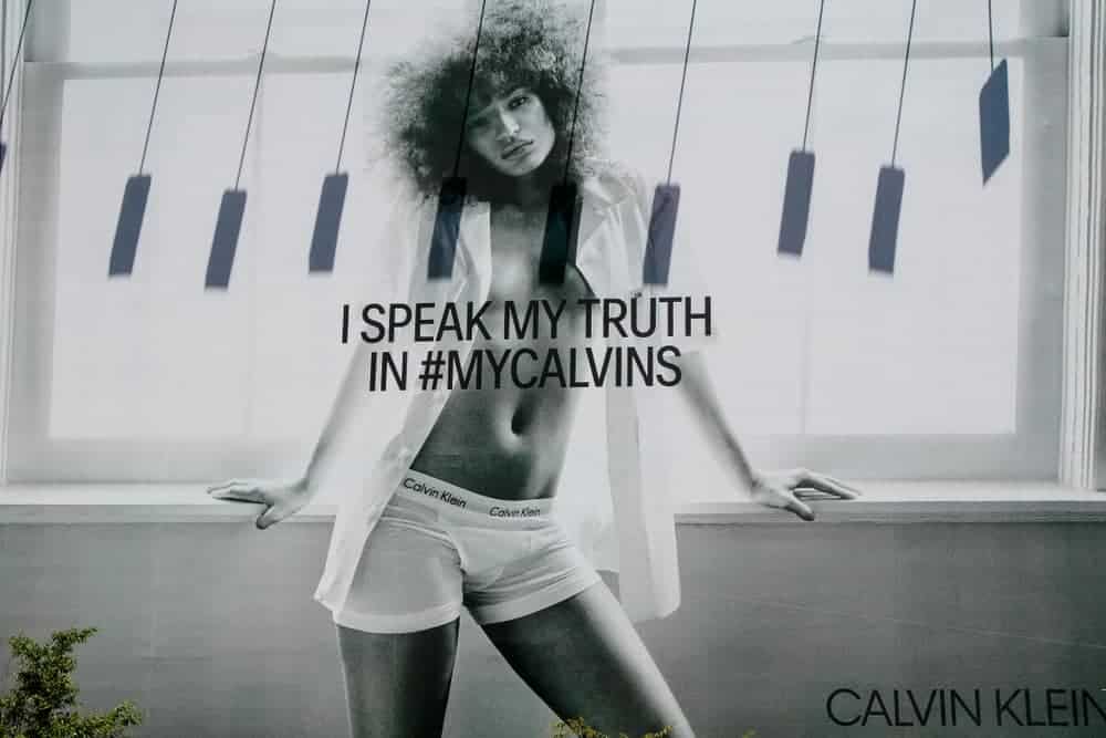 A billboard showcasing the Calvin Klein ad with a woman wearing lingerie.