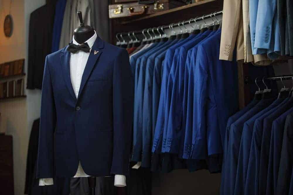 Display of men's suits in a boutique.
