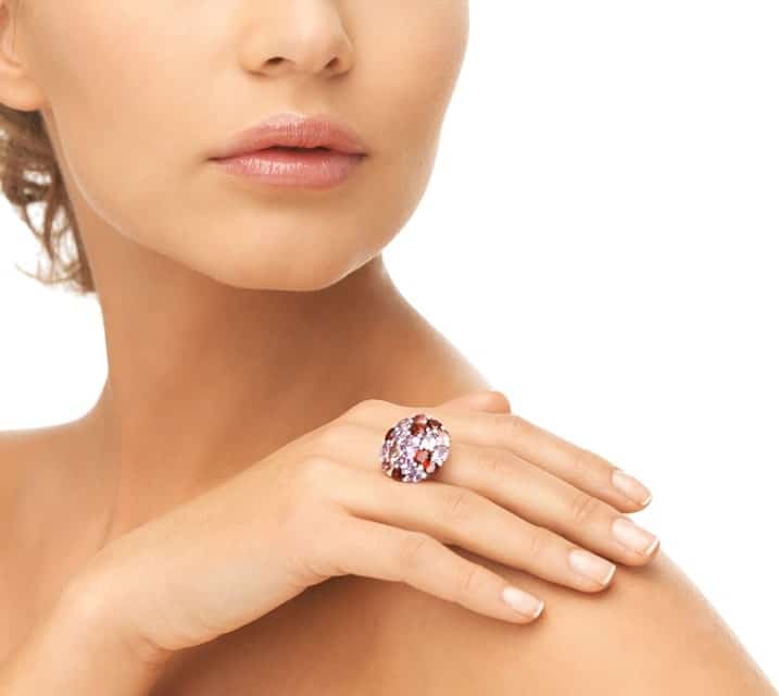 This is a close look at a woman wearing a cocktail ring.