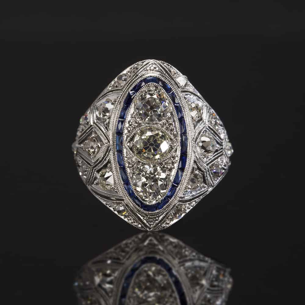 This is a close look at an estate ring against a dark surface.