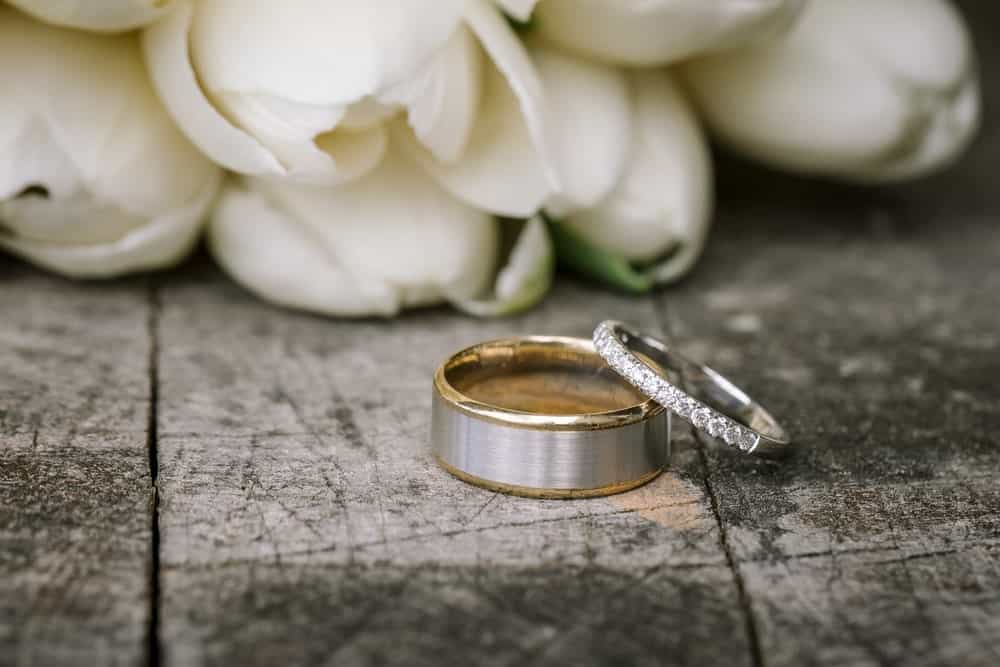 This is a close look at a couple of wedding bands with white roses.