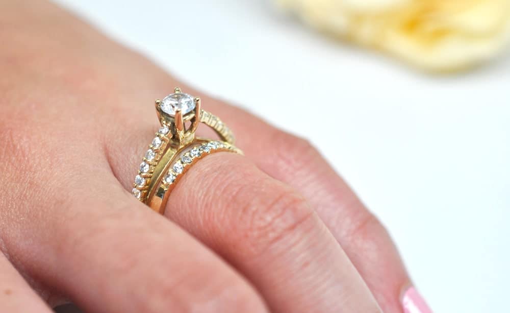 A close look at a bridal set ring that has gold bands and diamonds.