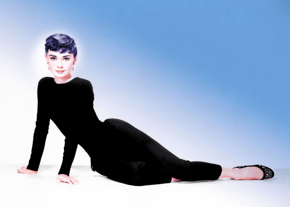 Audrey Hepburn wearing black long sleeves and pants.