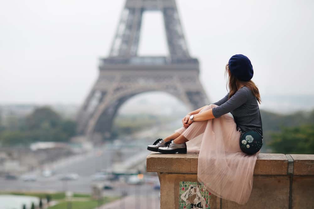 Woman in sheer skirt staring at the eiffel tower.