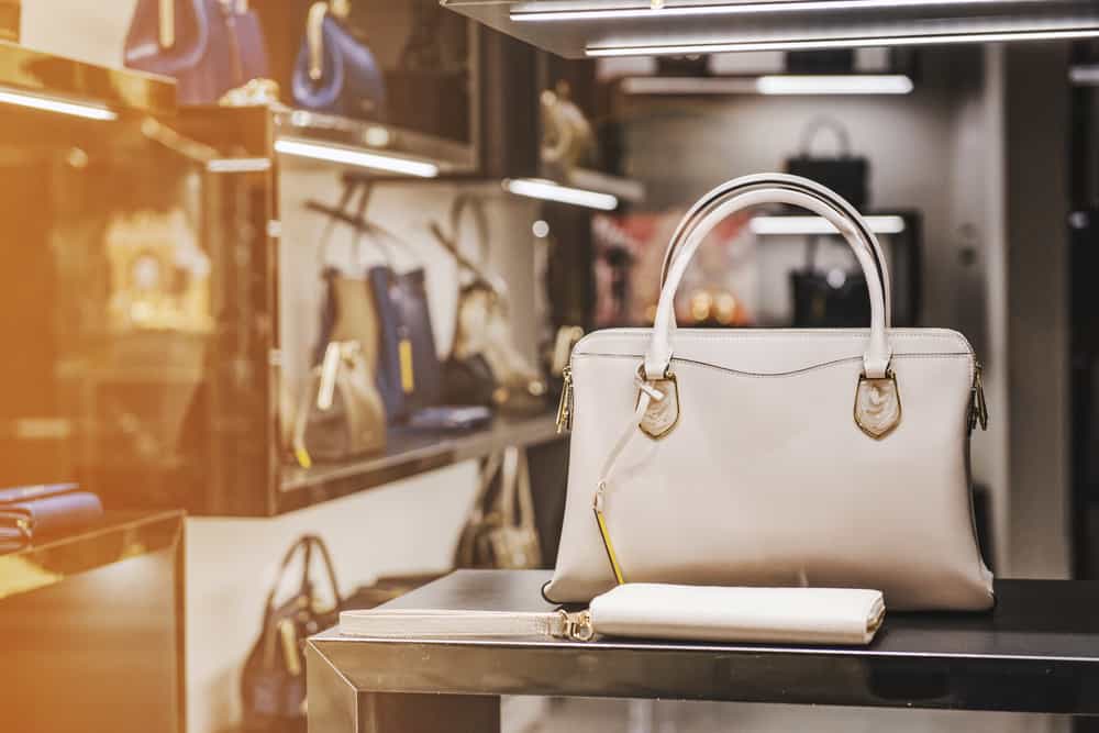 A close look at a handbag and matching wallet on display at a store.