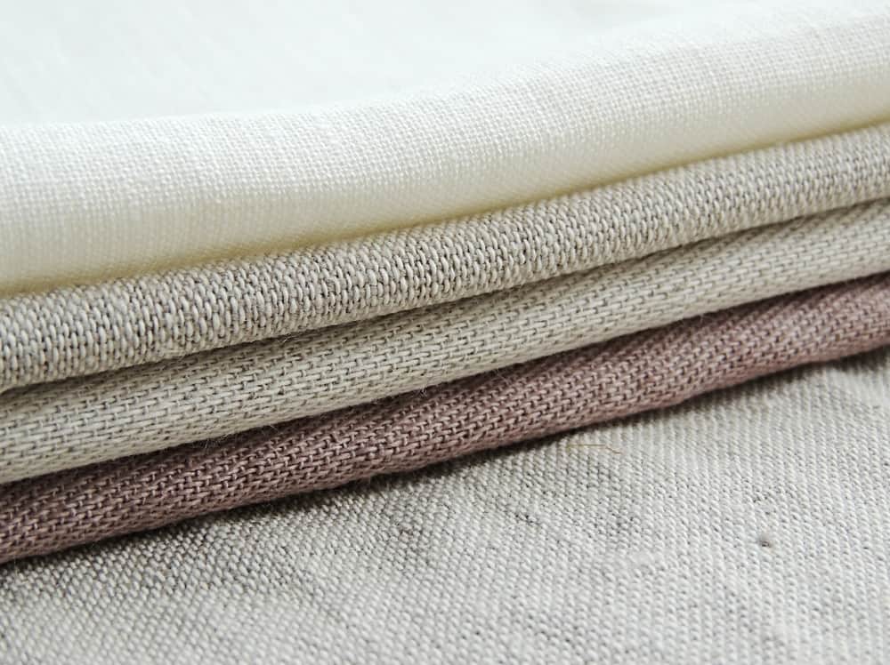 This is a close look at a stack of Linen Fabrics.
