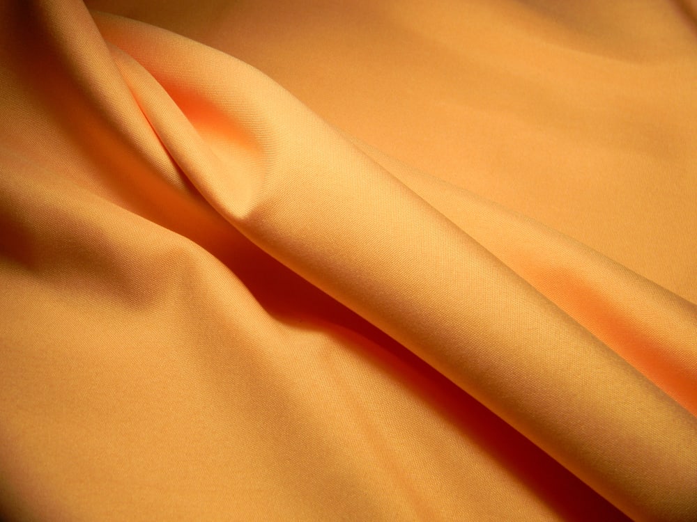 This is a close look at a peach colored Poplin fabric.