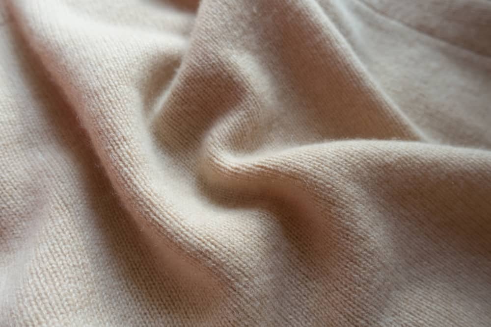 This is a close look at a beige wool fabric.