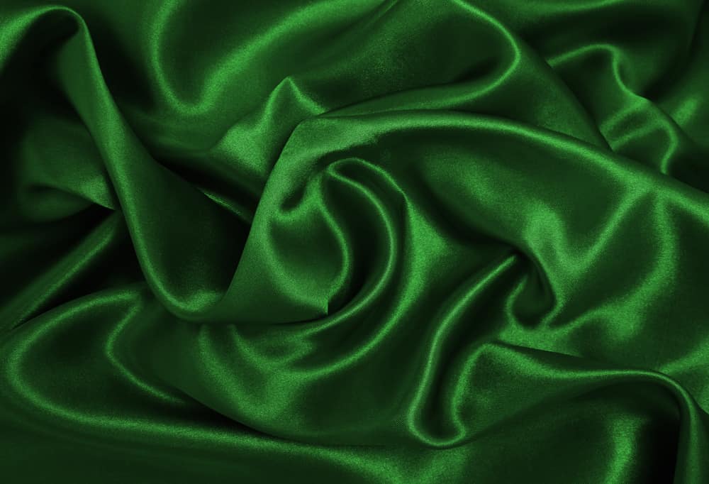 This is a close look at an emerald green silk fabric.