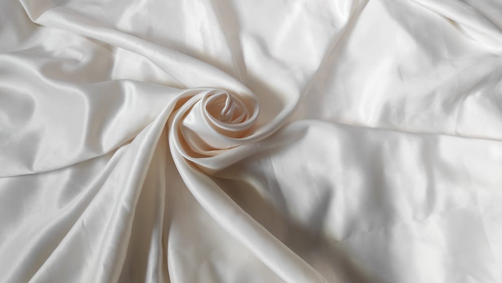 This is a close look at a pearly white sateen fabric.