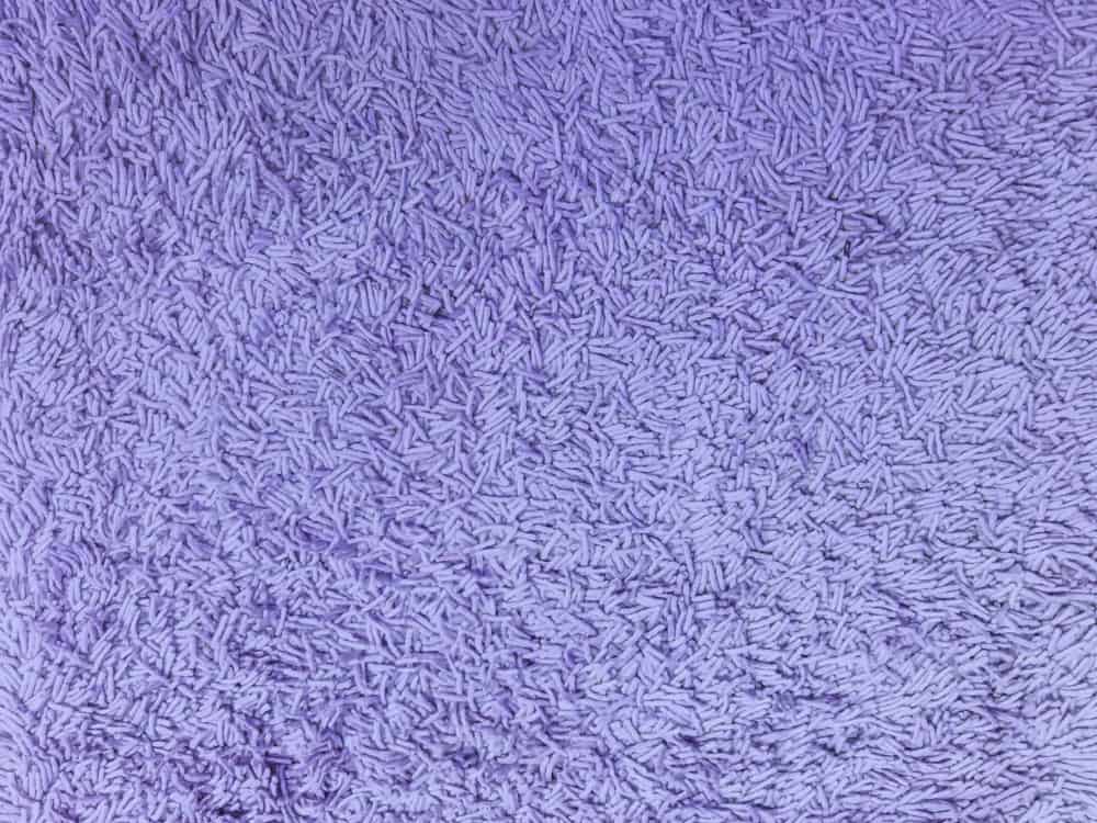 This is a close look at a purple Chenille fabric.