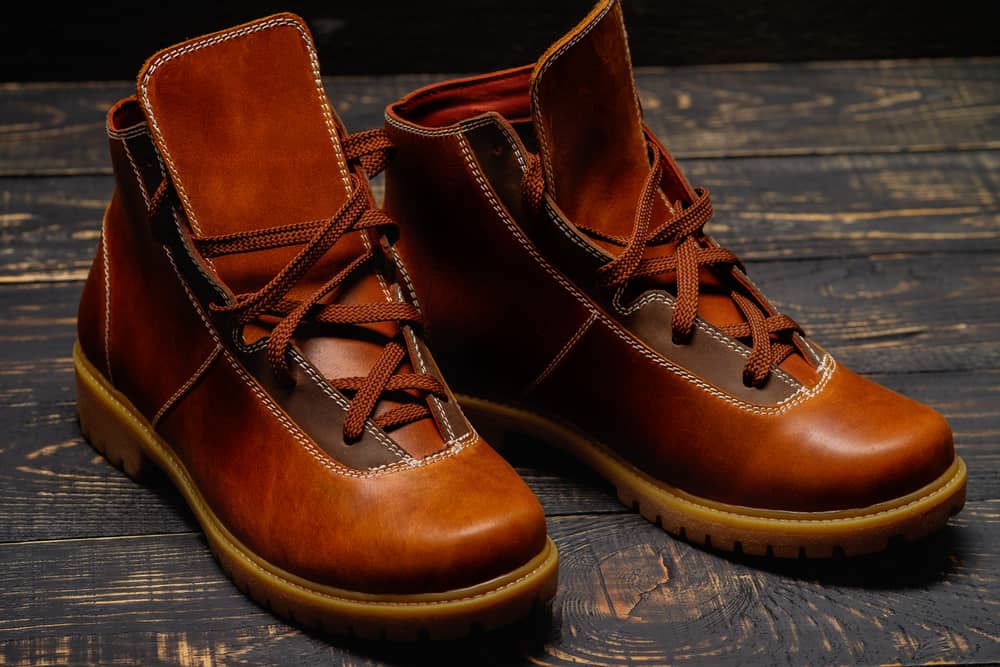 This is a close look at a pair of trendy brown leather laced boots.
