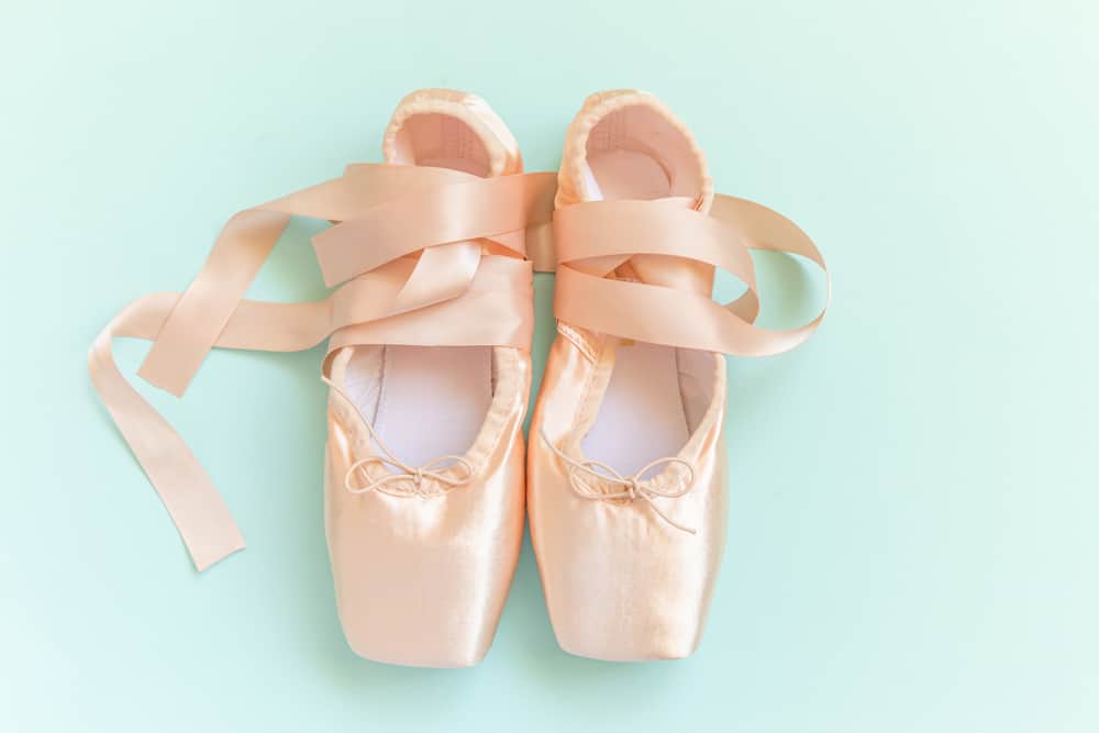 This is a close look at a pair of satin ballet shoes.