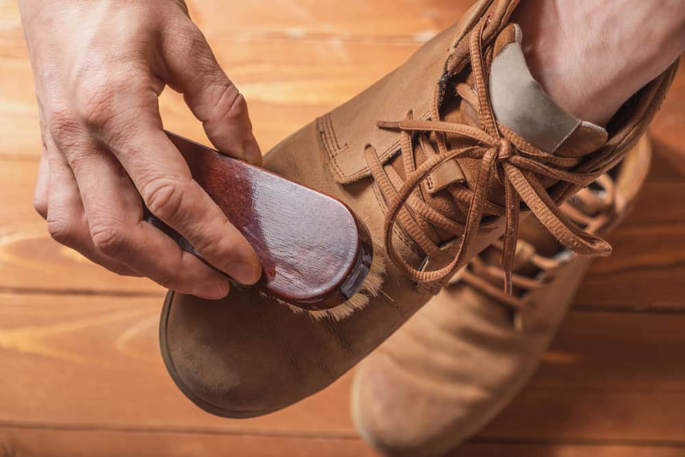 This is a close look at a man brushing his Nubuck leather shoes.