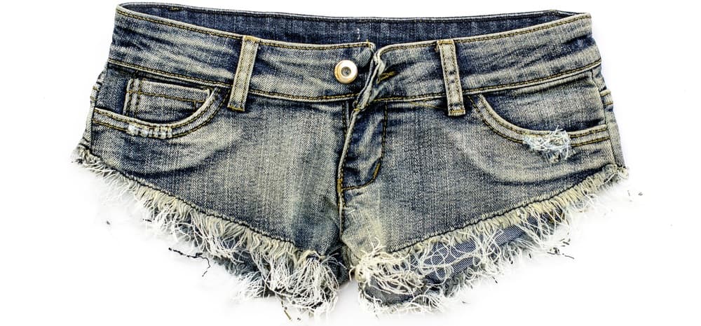 This is a close look at a pair of frayed jean shorts.