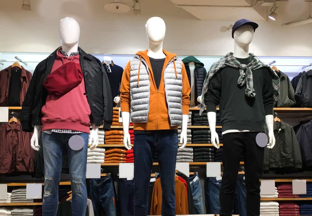 Men's clothing store with mannequins and shelves.