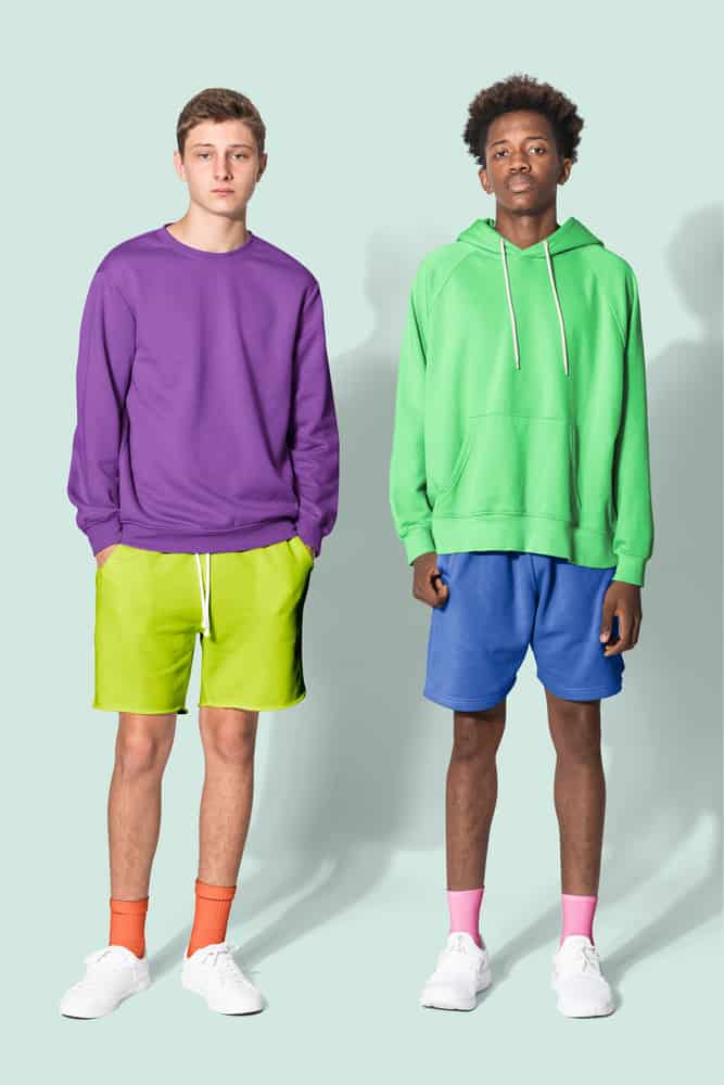Teenage boys wearing colorful sweaters and shorts. 