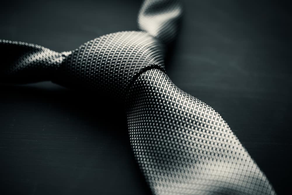 This is a close look at a gray tie with minute patterns.