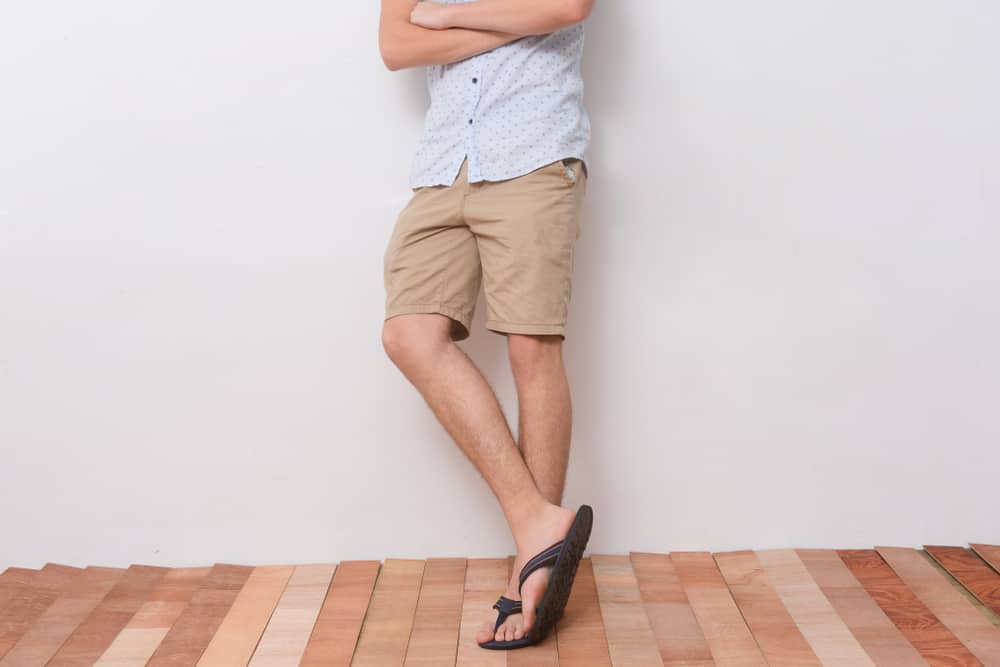 A close look at a man wearing a pair of khaki shorts.