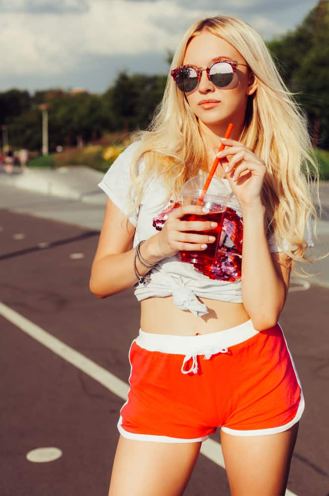 This is a close look at a woman wearing a pair of red short shorts.