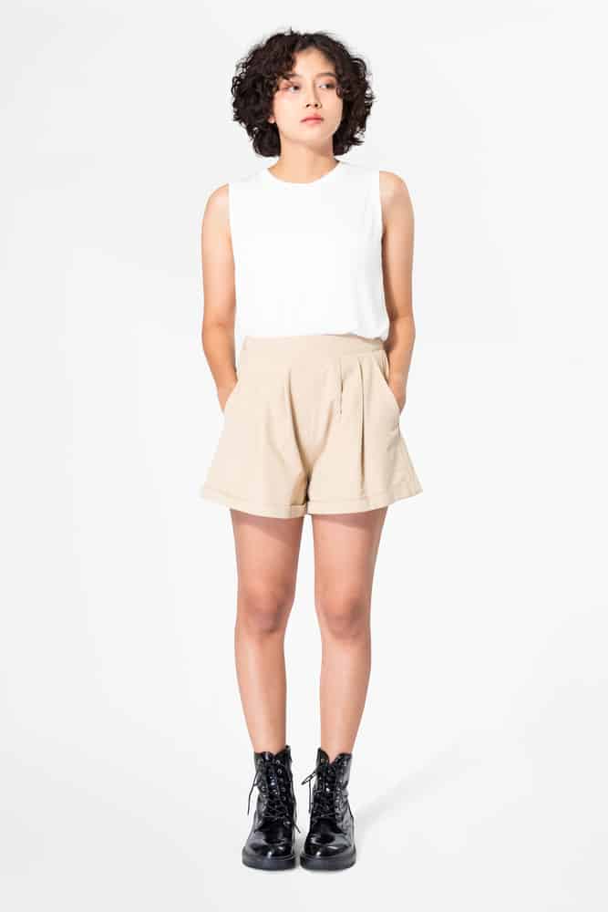 A woman wearing a pair of pleated shorts.