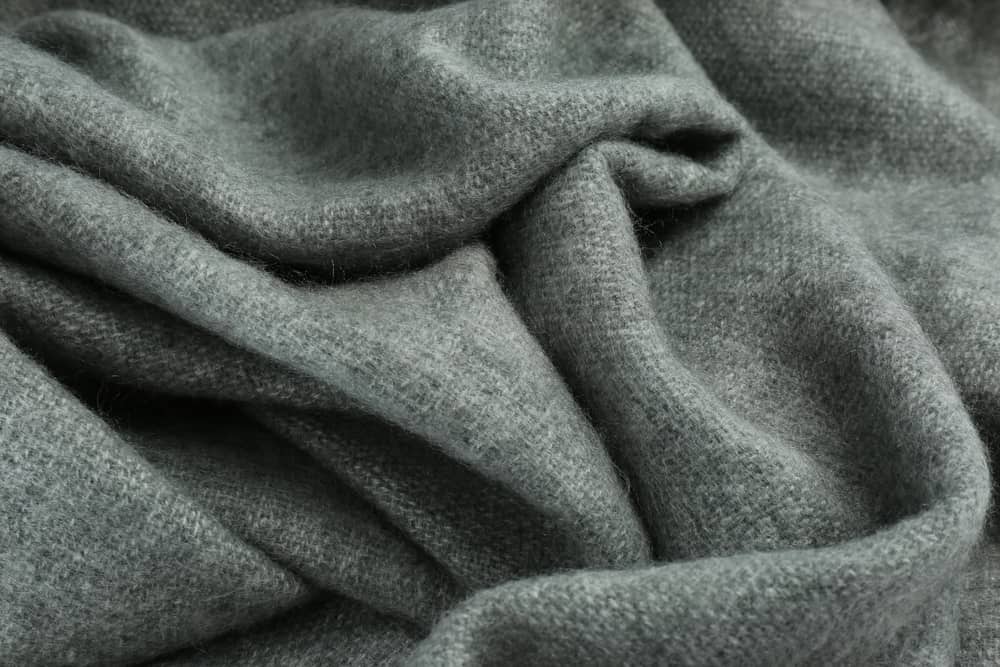 This is a close look at a gray cashmere wool scarf.