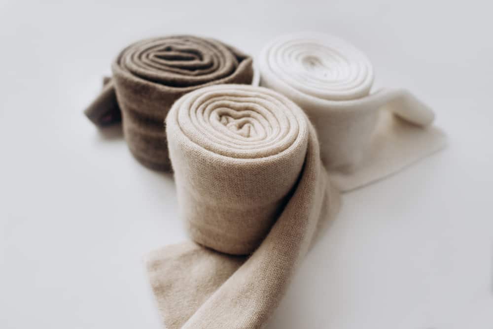 A close look at rolls of cashmere scarves.