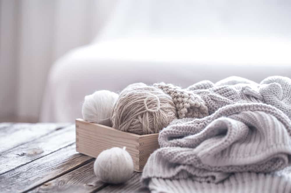 A close look at knitted sweaters and balls of yarn.