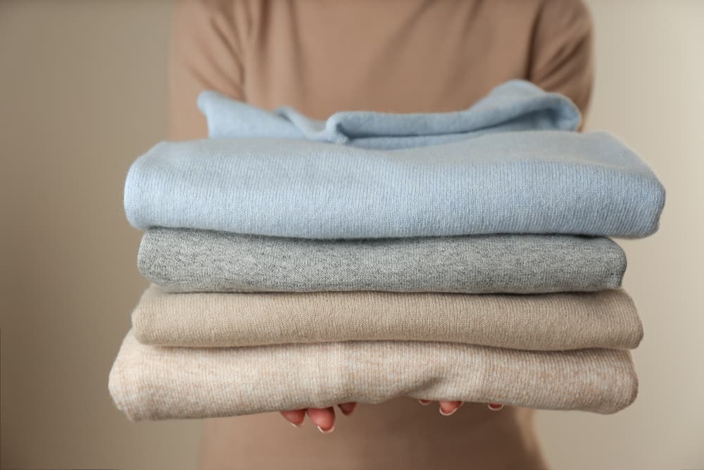 A stack of pastel-toned cashmere sweaters.