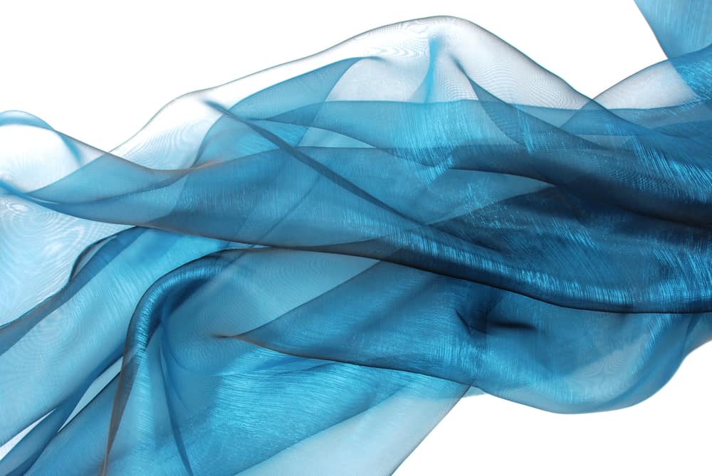 This is a close look at a piece of blue organza silk cloth.