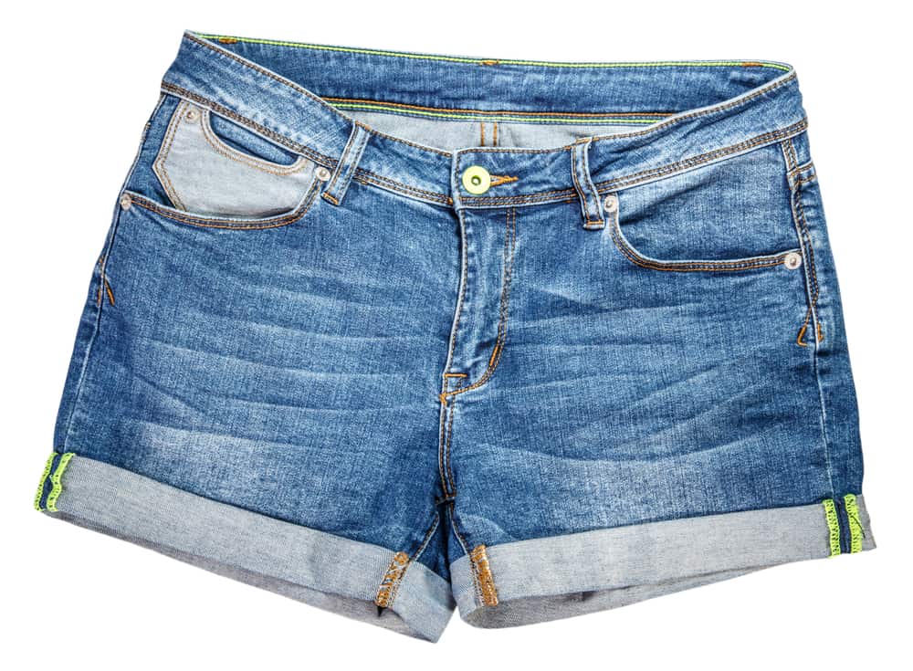 This is a close look at a  pair of denim shorts with cuffs.