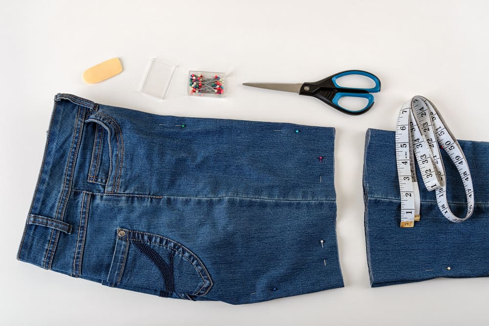 This is a close look at a pair of denim pants in the process of being converted into a pair of shorts.