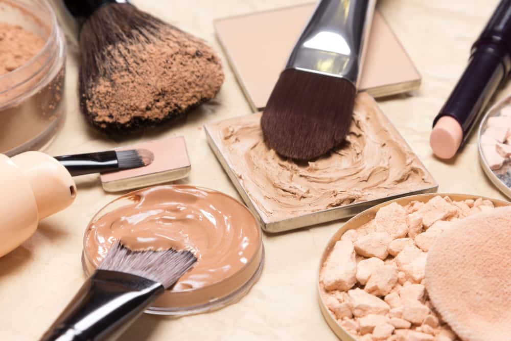 Set of makeup foundations with brushes.
