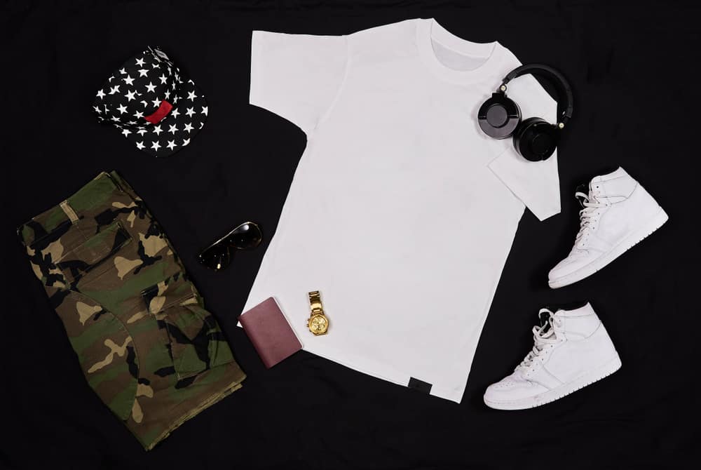 This is a close look at a complete outfit with accessories paired with a pair of camo shorts.