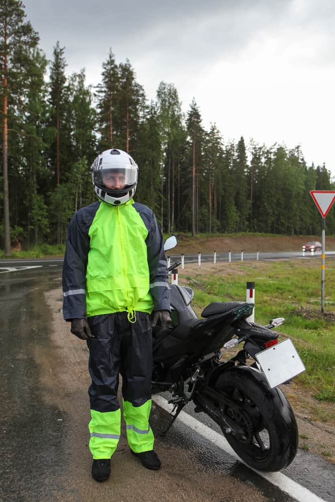 A rider wearing a full suit made of waterproof materials.