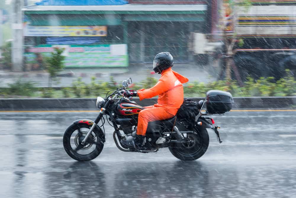 This is a rider riding his motorcycle through the rain.