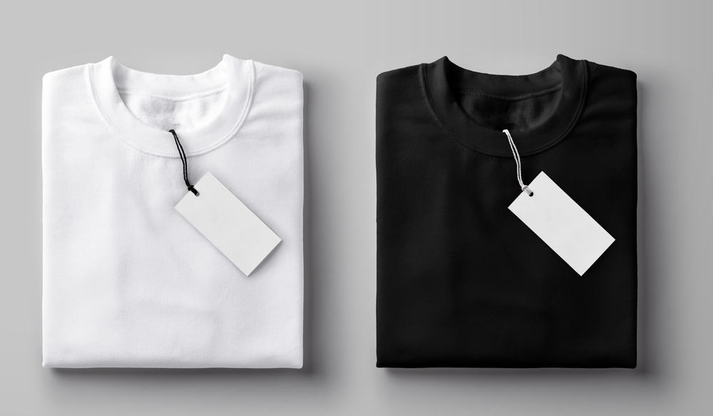 This is a close look at black and white T-shirts folded with their tags on.