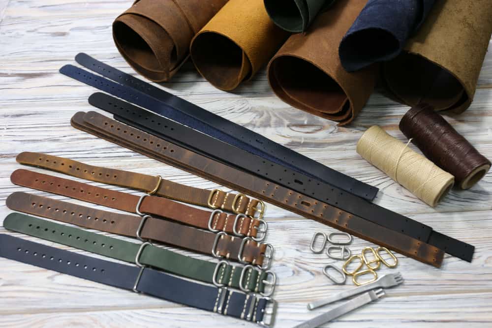 Various leather watch straps along with rolls of genuine leather.