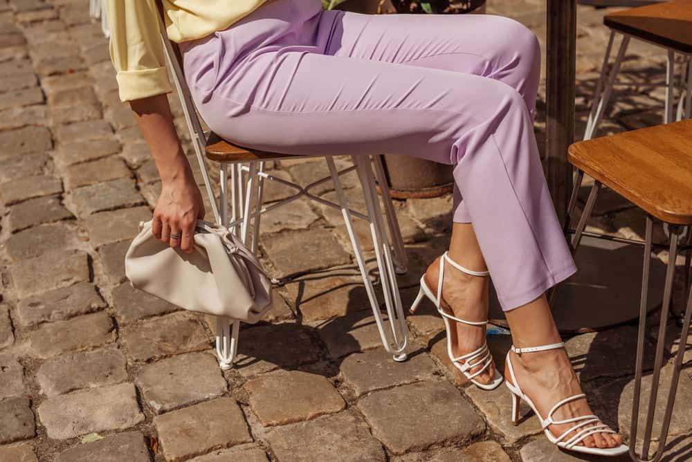 This is a close look at a woman wearing a pair of lilac trousers.