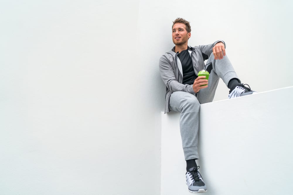 A man wearing exercise clothes with sweatpants.