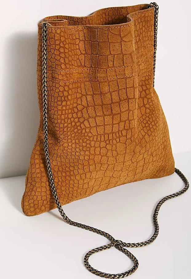 The Nicolette Suede Crossbody in brown by Free People.