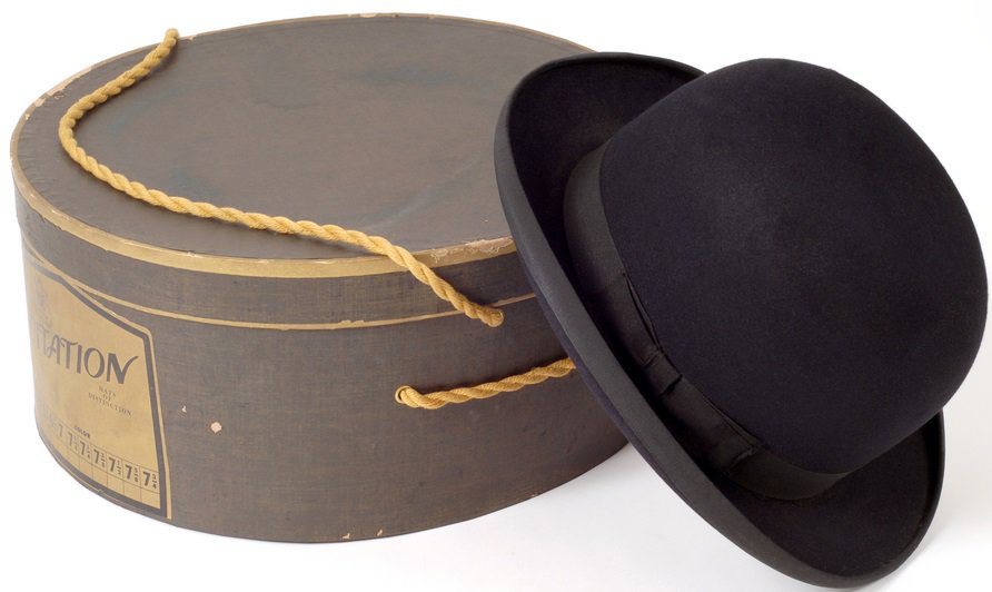An old black derby hat and its box.