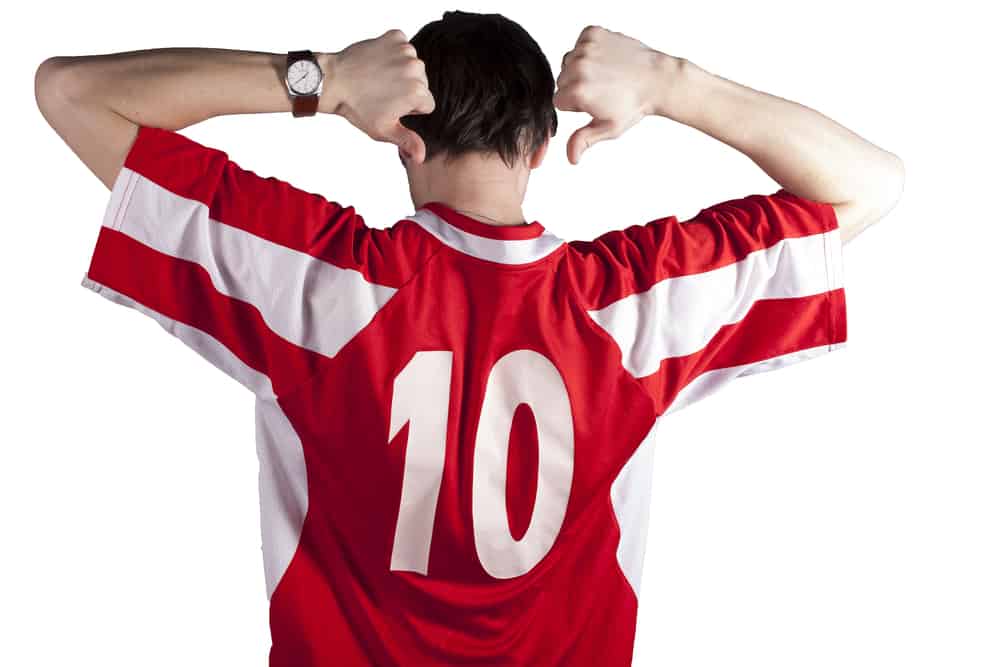 A man wearing a red jersey shirt with the number 10.