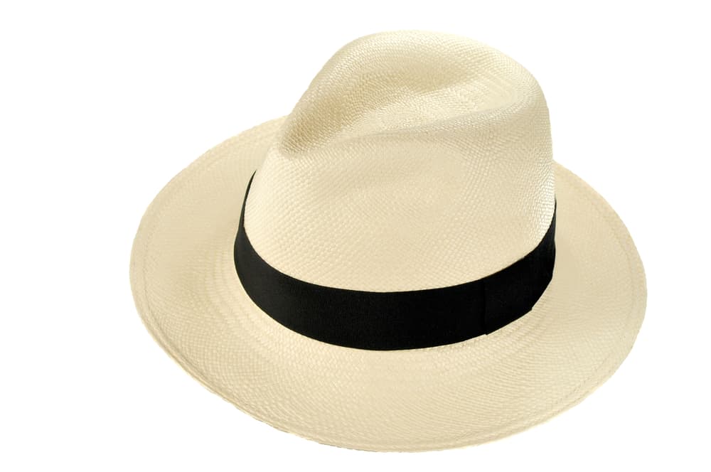 A traditional beige Panama hat with dark band.