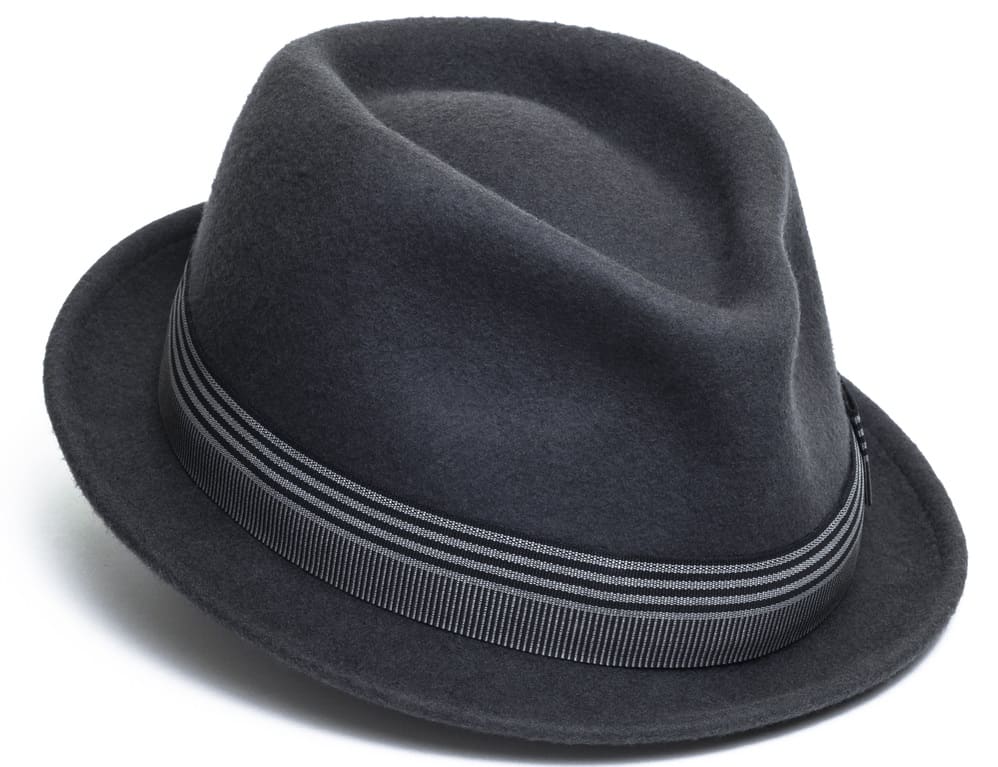 This is a close look at a dark gray trilby hat with patterned band.