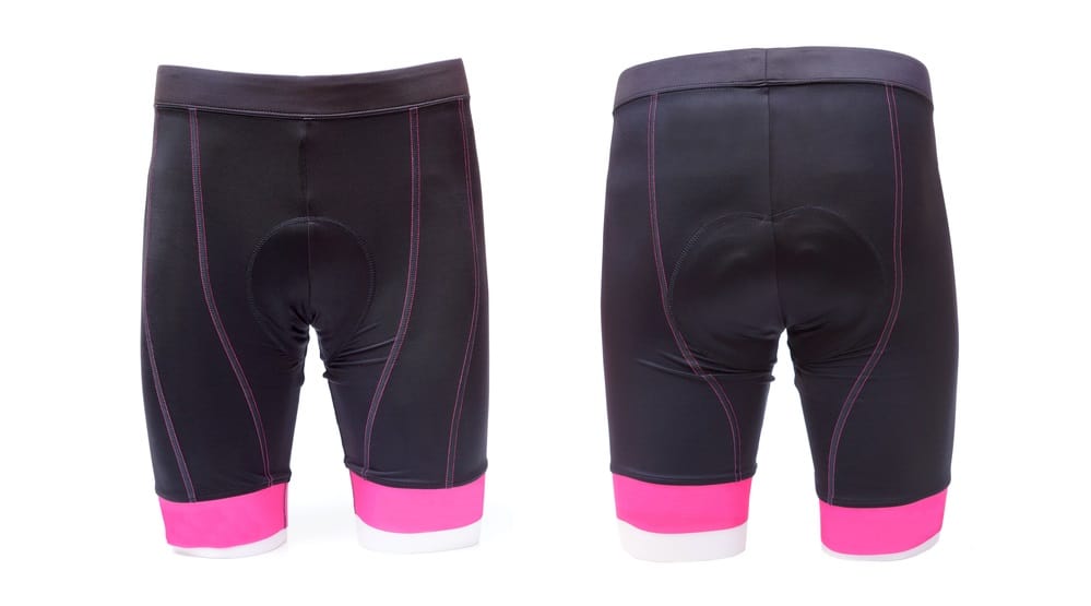Front and back view of black padded shorts with pink trims.