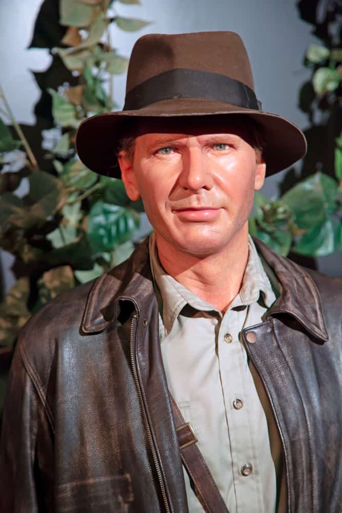 This is a close look at the wax statue of Indiana Jones wearing a fedora.